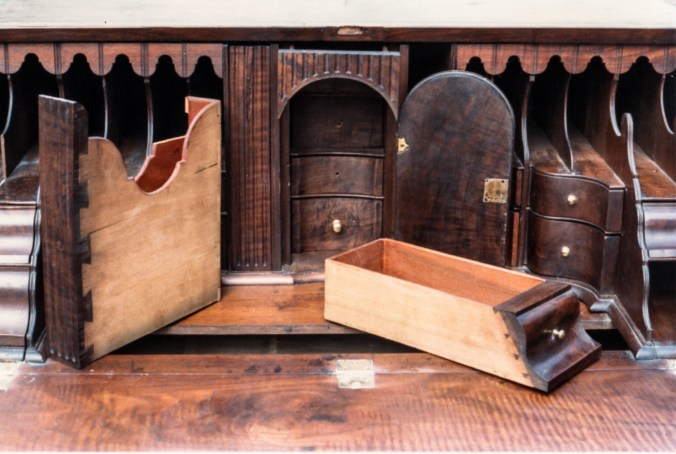The horizontal grain of the sides of the document drawers are dovetailed to the vertical grain of the walnut fronts.